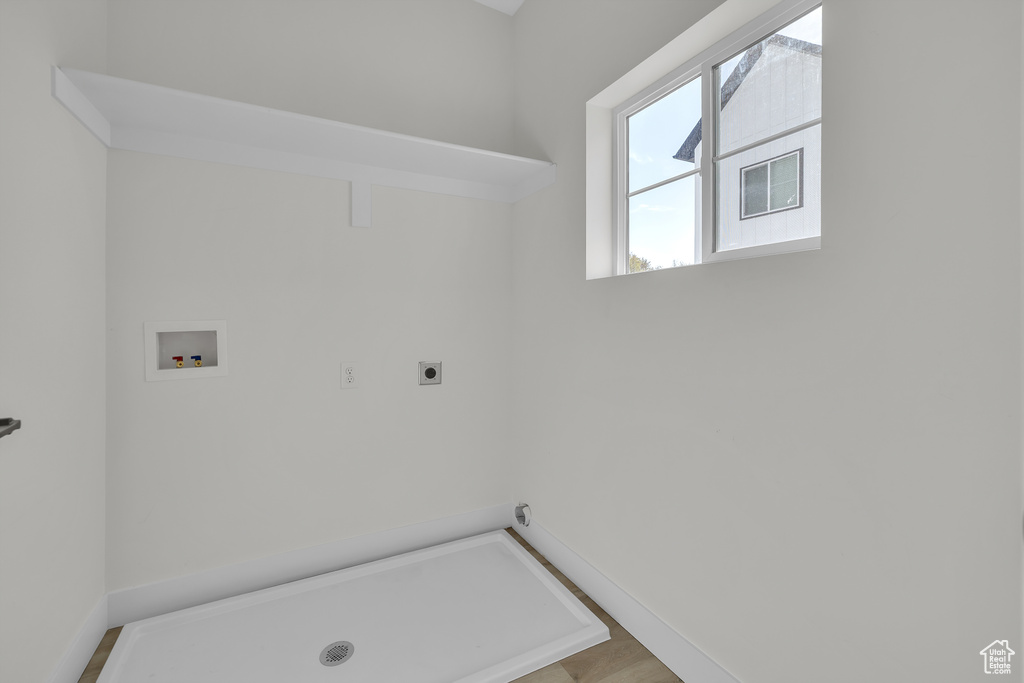 Laundry area featuring electric dryer hookup, hookup for a washing machine, and baseboards