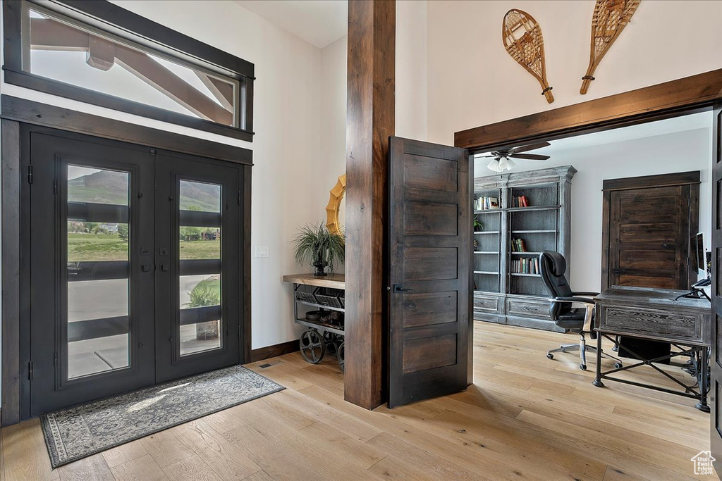 Entrance foyer featuring french doors and wood finished floors