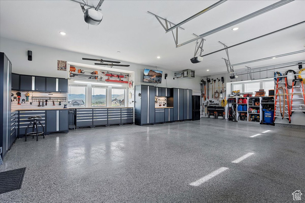 Garage with a garage door opener and recessed lighting