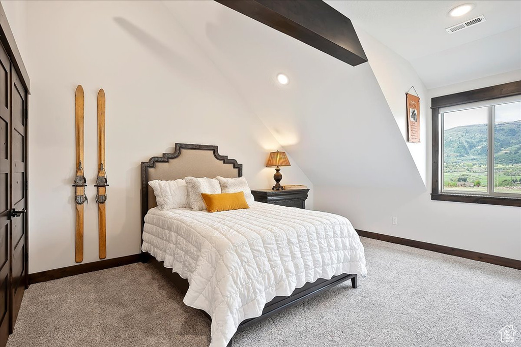 Carpeted bedroom with vaulted ceiling, baseboards, and recessed lighting