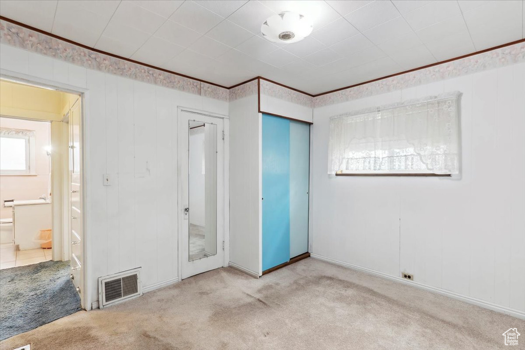 Unfurnished bedroom featuring carpet floors and a closet