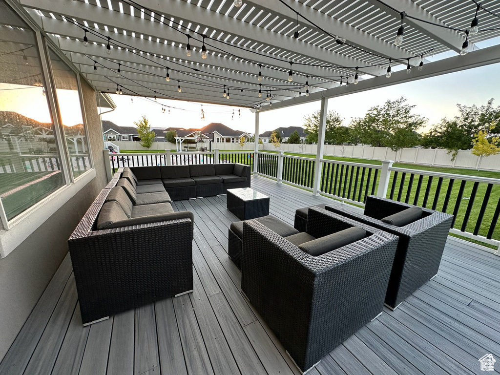 Deck featuring an outdoor living space and a pergola