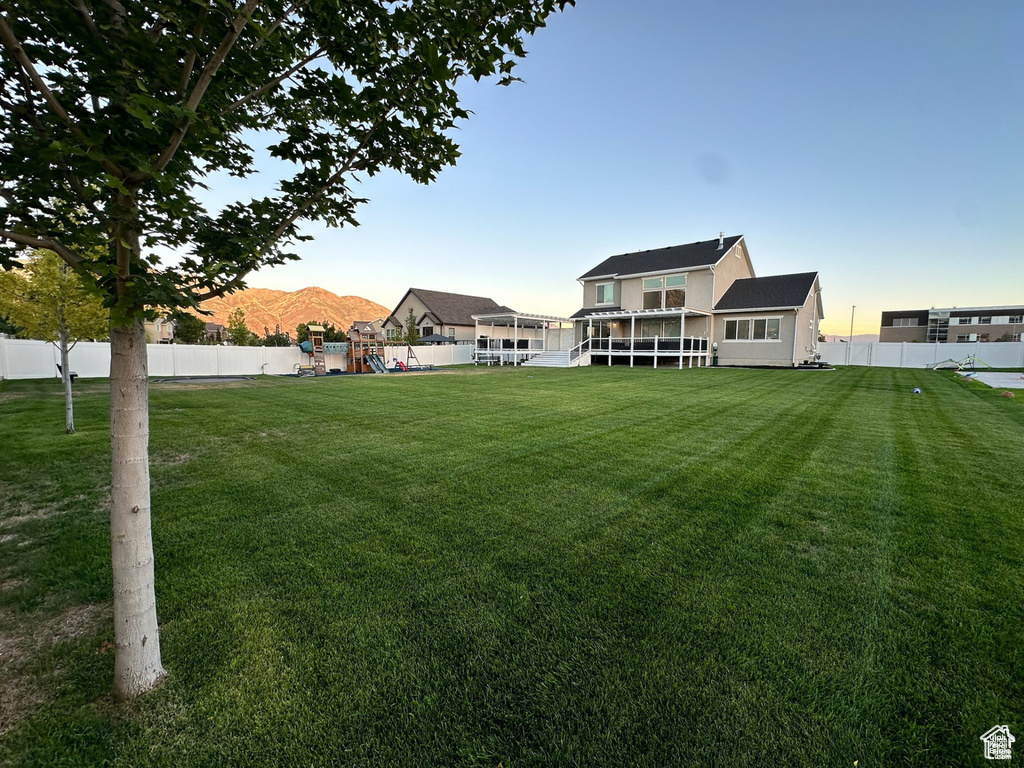 View of yard with a playground and a mountain view