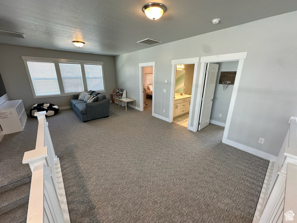 Carpeted living area with baseboards