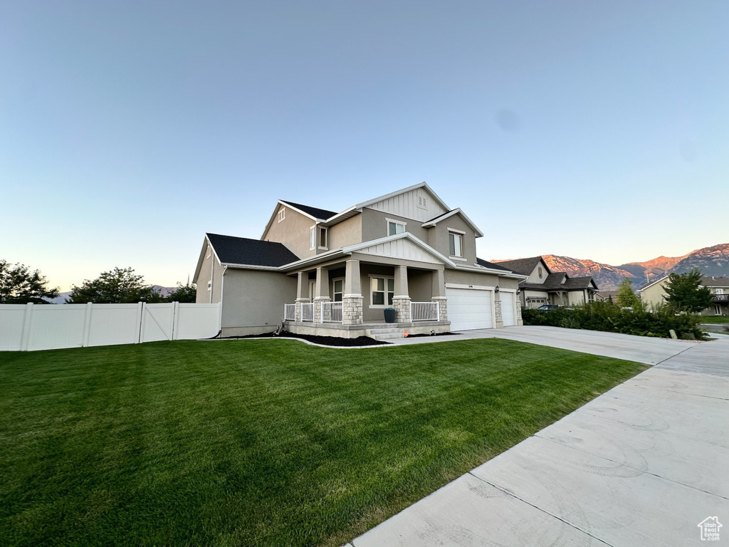 Craftsman inspired home featuring covered porch, concrete driveway, and stucco siding