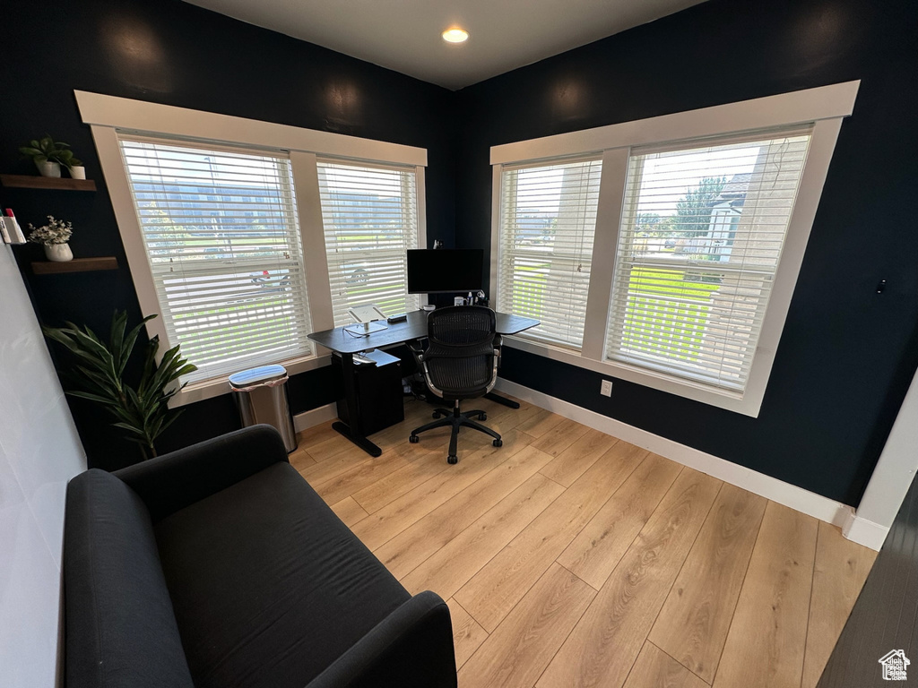 Office space with baseboards, light wood finished floors, and recessed lighting