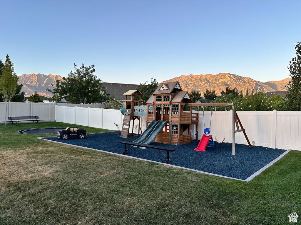 View of jungle gym with a mountain view
