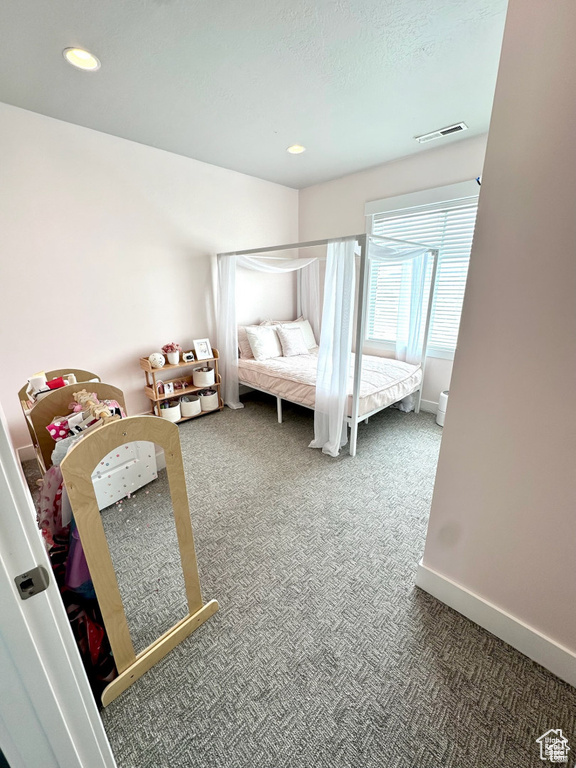 Carpeted bedroom featuring recessed lighting and baseboards