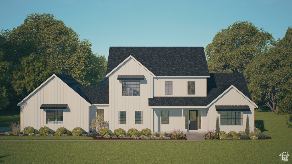 View of front of property with board and batten siding, a front yard, and roof with shingles