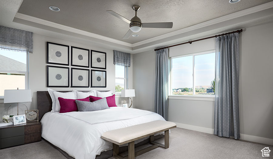 Bedroom with crown molding, a raised ceiling, baseboards, carpet flooring, and a textured ceiling