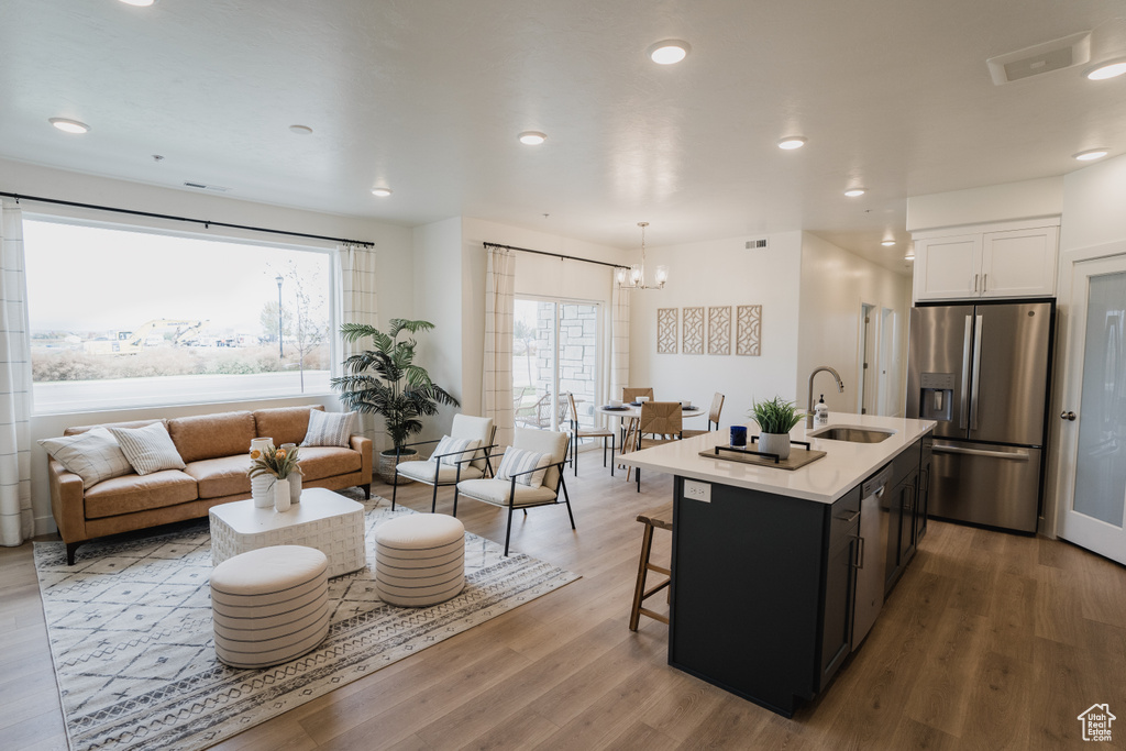 Kitchen with stainless steel appliances, a sink, a chandelier, healthy amount of natural light, and recessed lighting