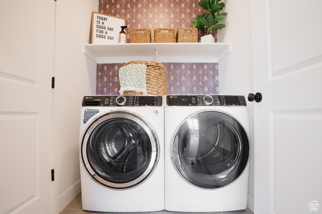 Washroom featuring washing machine and clothes dryer