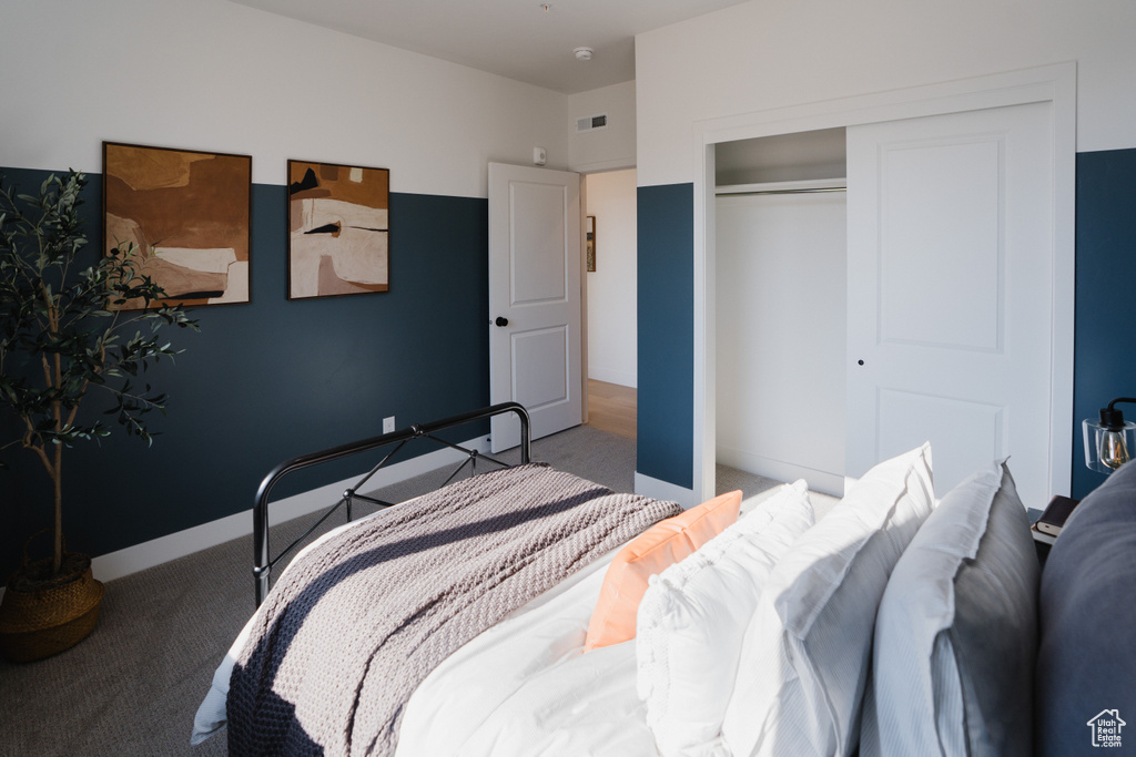 Carpeted bedroom featuring a closet