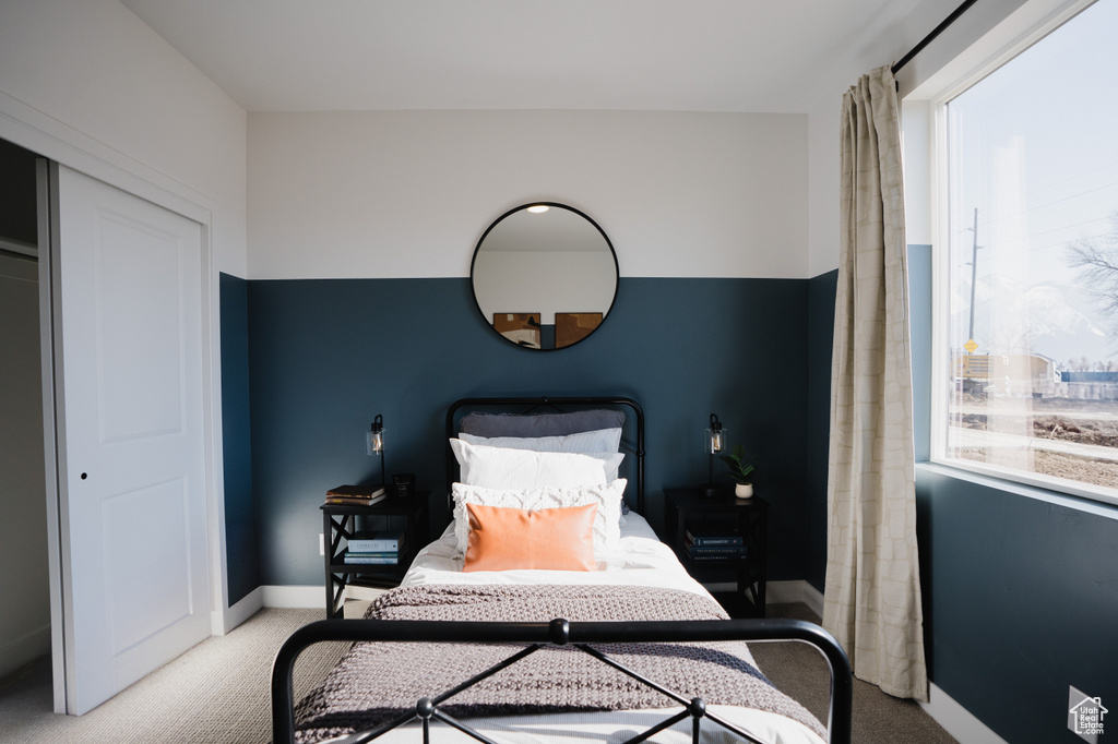 Bedroom with carpet floors and baseboards
