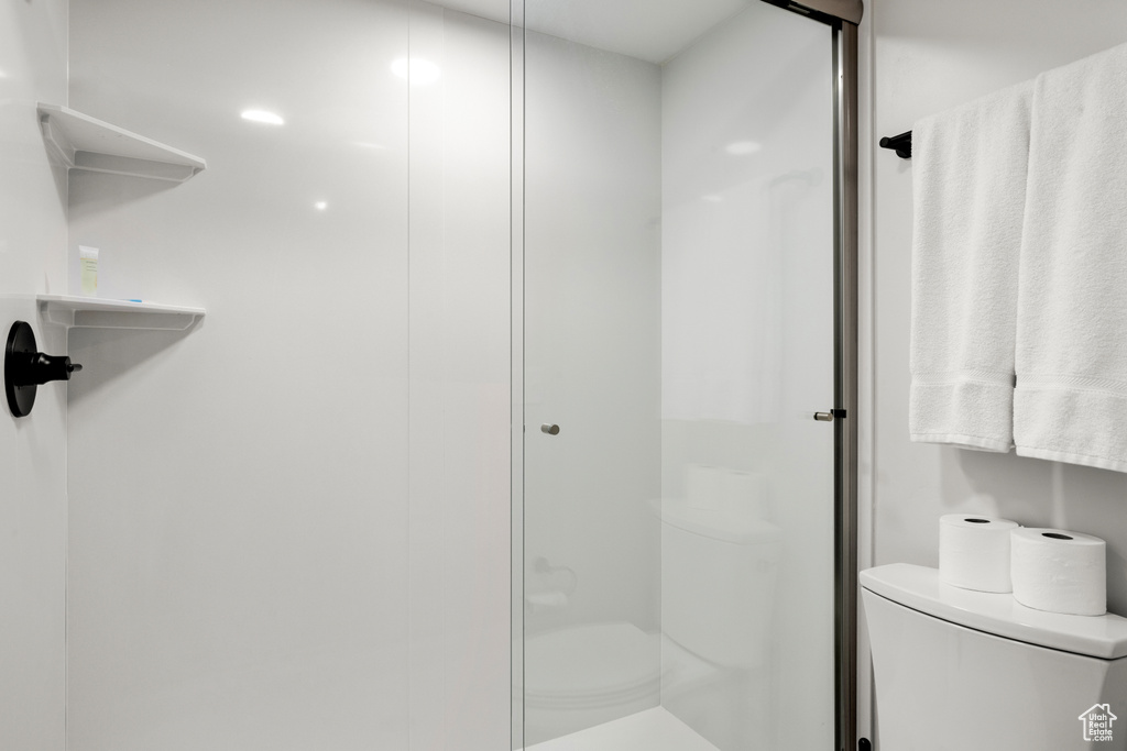 Full bathroom featuring toilet and an enclosed shower