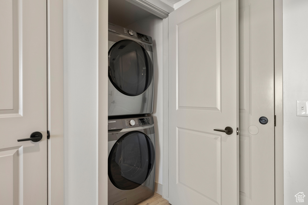 Laundry area featuring stacked washer / drying machine