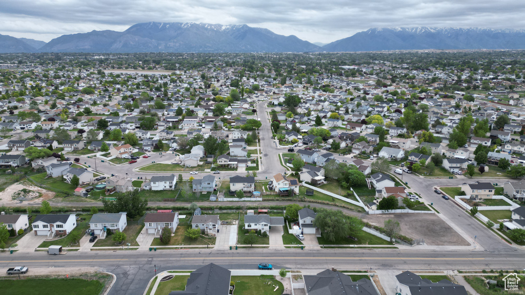 Aerial overview of property's location with a mountain backdrop and nearby suburban area