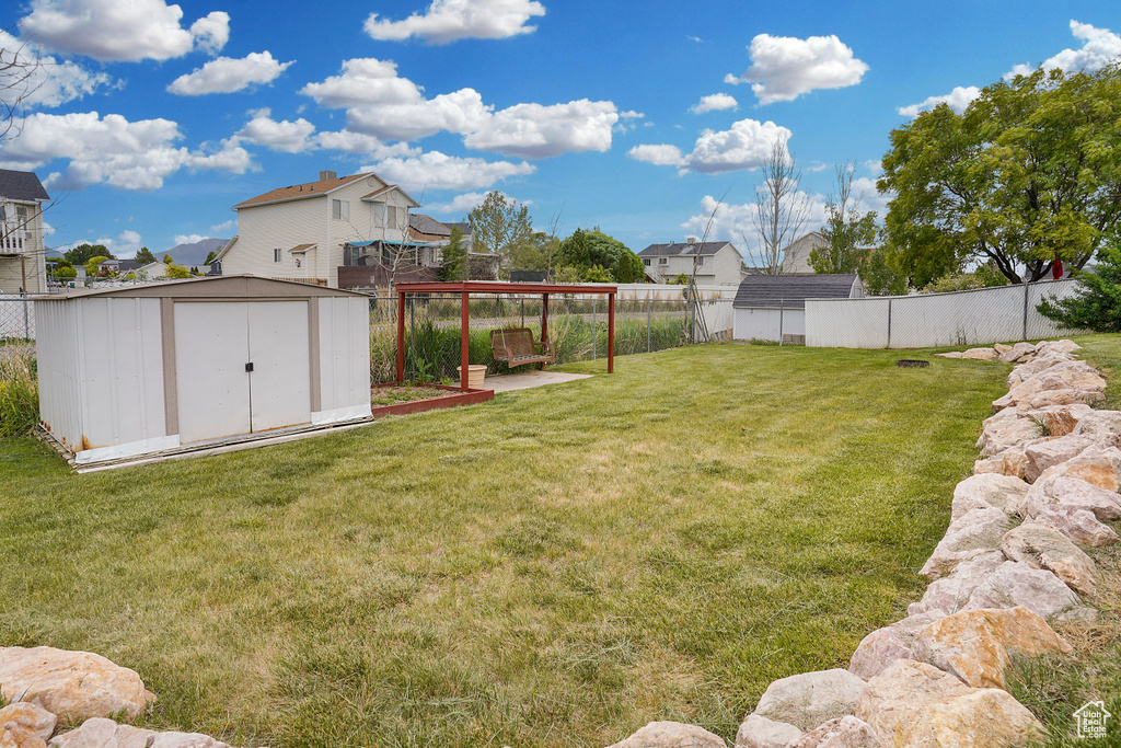 View of yard with a storage unit and an outdoor structure