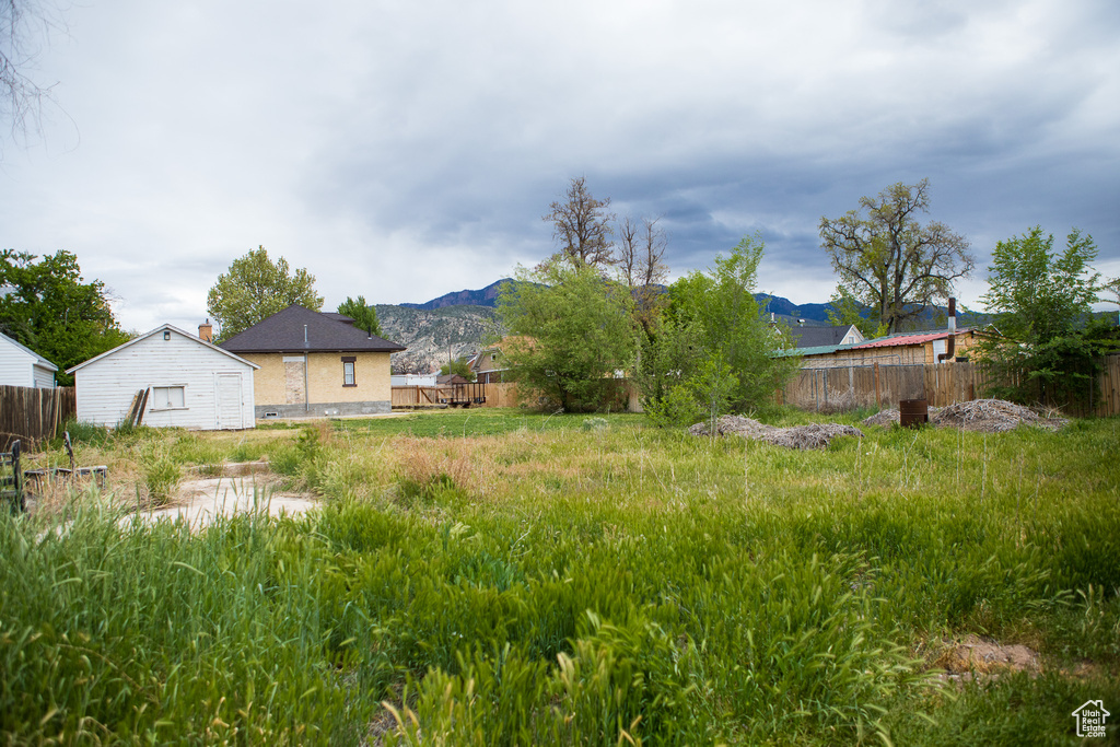 View of yard featuring fence and a mountain view