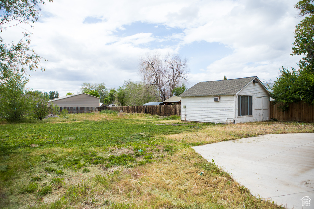 View of yard with an outbuilding and a patio
