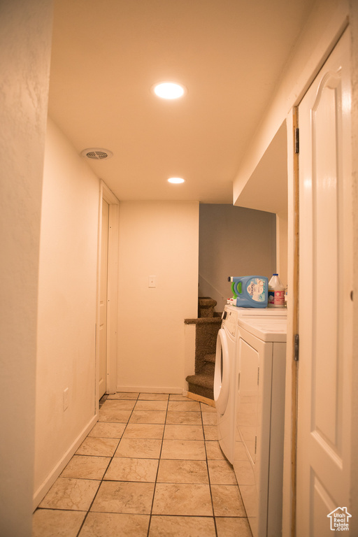 Laundry area featuring washer and dryer, recessed lighting, baseboards, and light tile patterned flooring