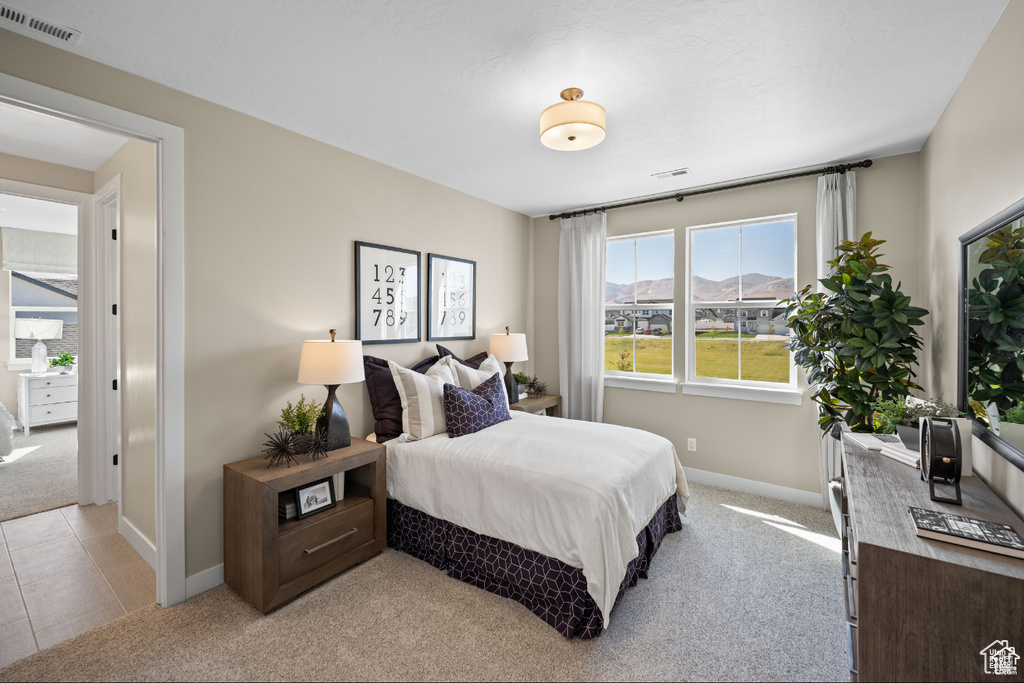 Bedroom with light carpet and baseboards