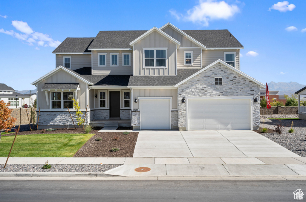 View of front of home featuring board and batten siding and stone siding