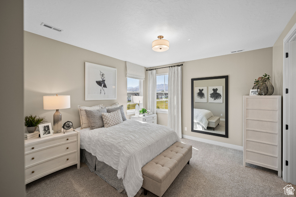 Carpeted bedroom featuring baseboards