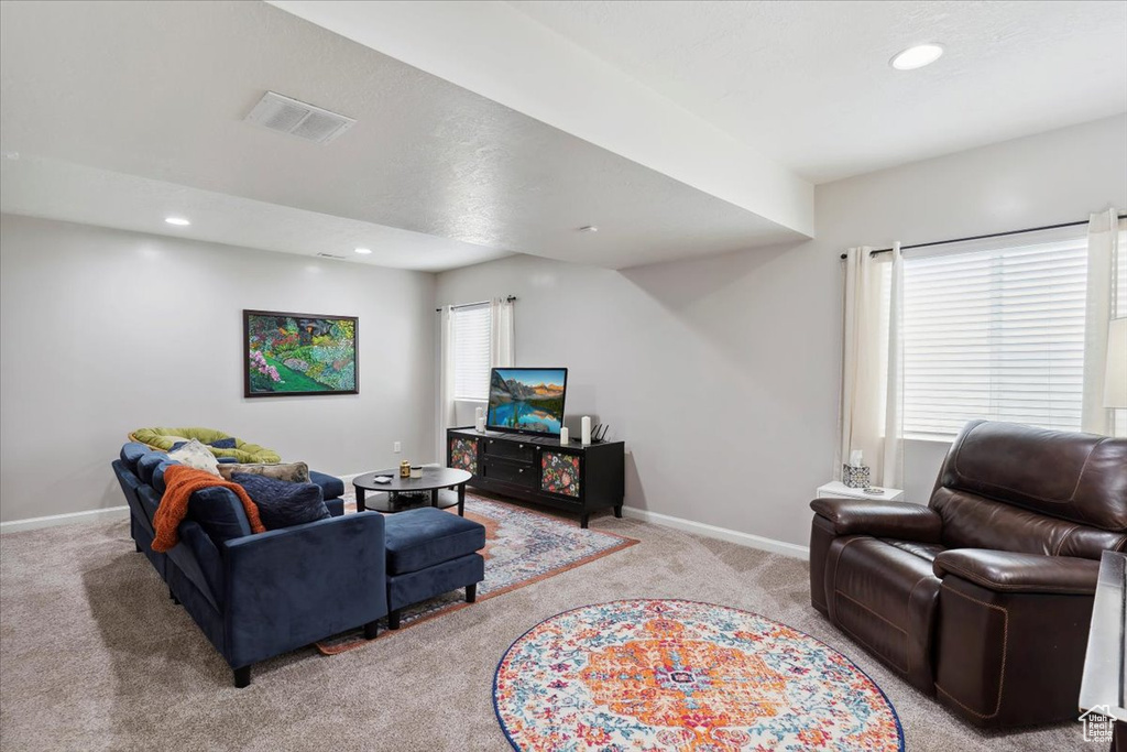 Living room with light carpet, baseboards, and recessed lighting