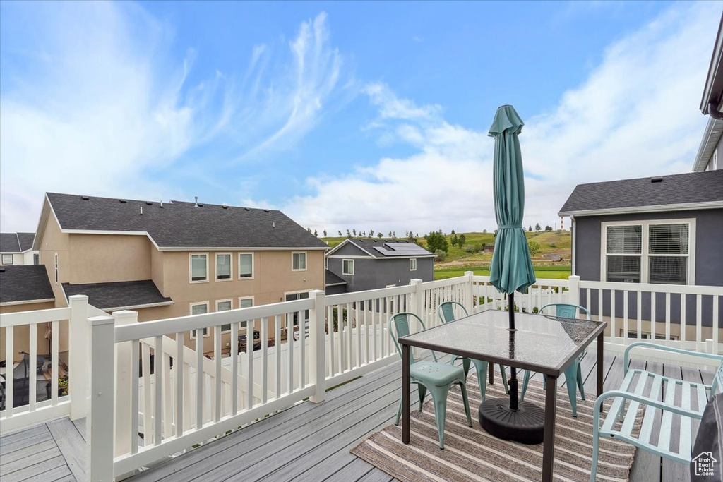 Deck with outdoor dining area and a residential view