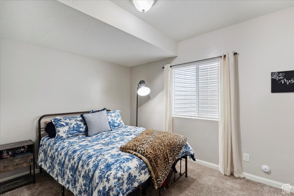 Carpeted bedroom featuring baseboards