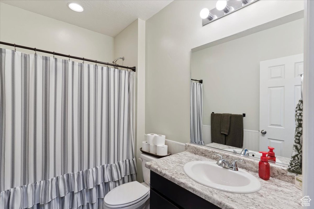 Full bathroom featuring vanity and toilet