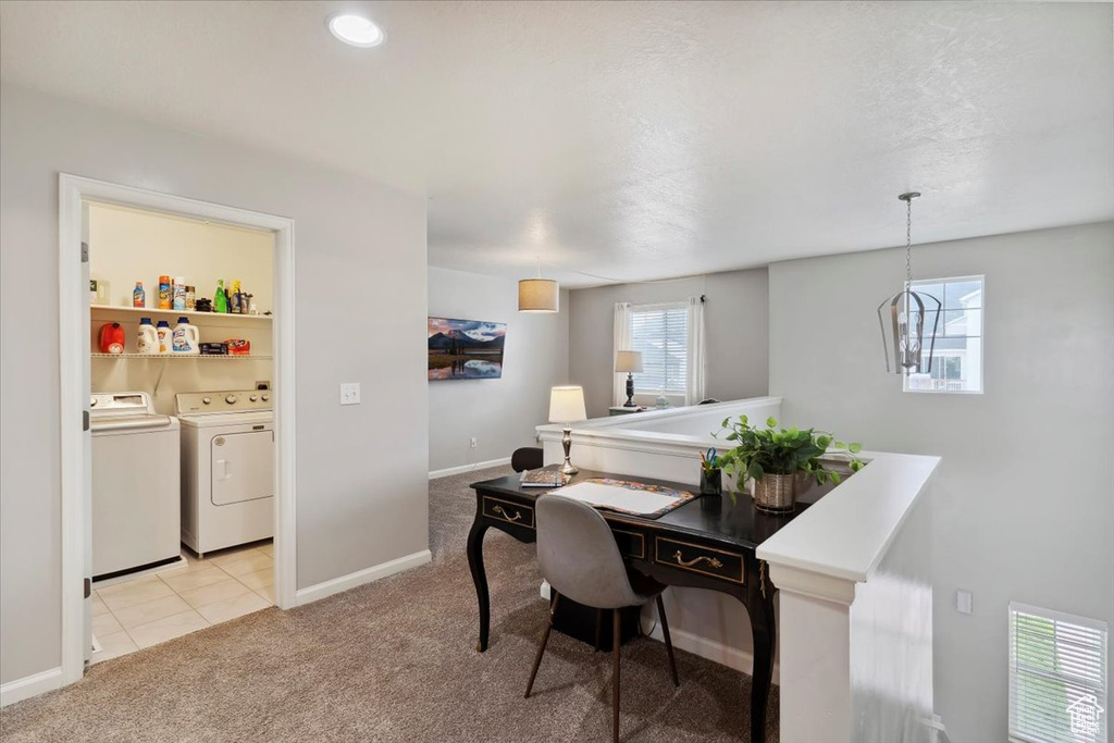 Office space featuring washer and dryer, light carpet, and baseboards