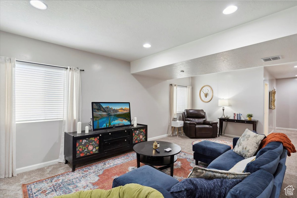 Carpeted living area featuring baseboards and recessed lighting