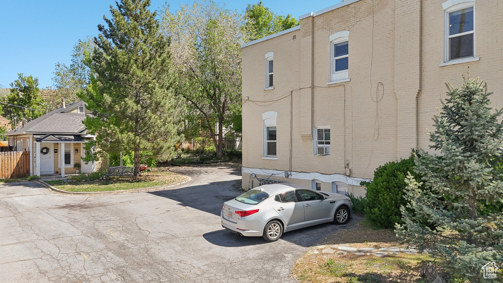View of property exterior featuring brick siding and driveway