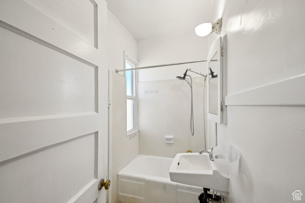 Full bath featuring a sink and  shower combination