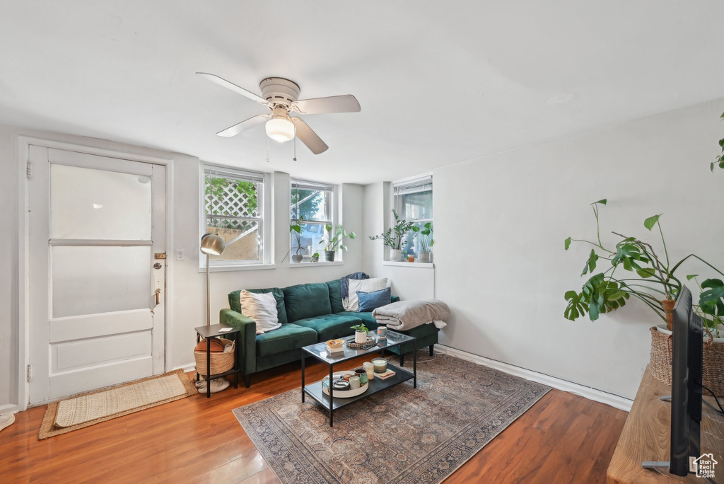 Living room with wood finished floors and a ceiling fan