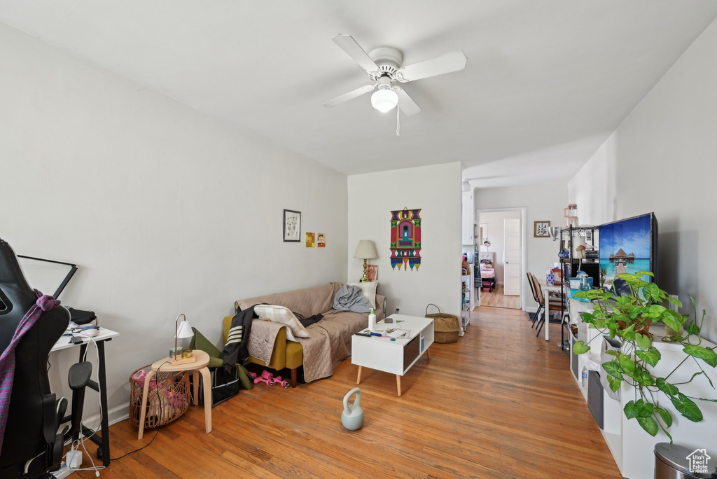 Living room featuring ceiling fan and wood finished floors