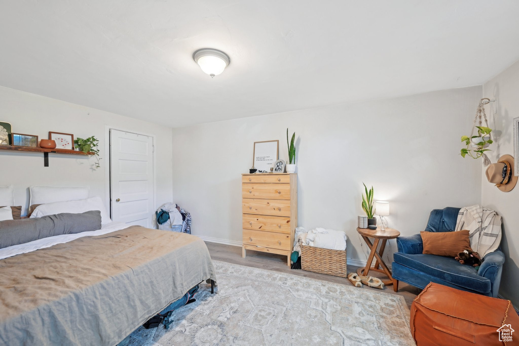 Bedroom with wood finished floors and baseboards