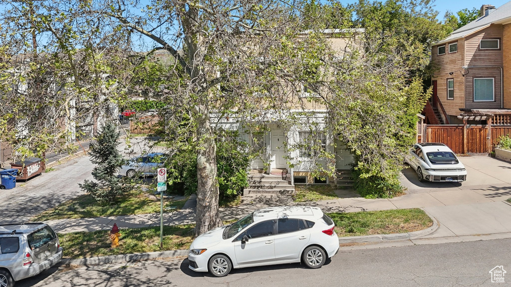View of front of home featuring fence