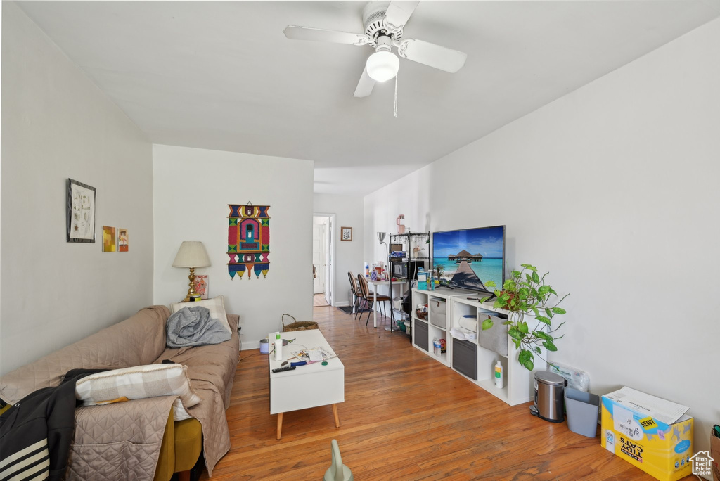 Living area with wood finished floors and a ceiling fan