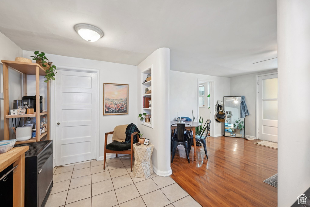 Interior space with wood counters, light wood finished floors, open shelves, and baseboards
