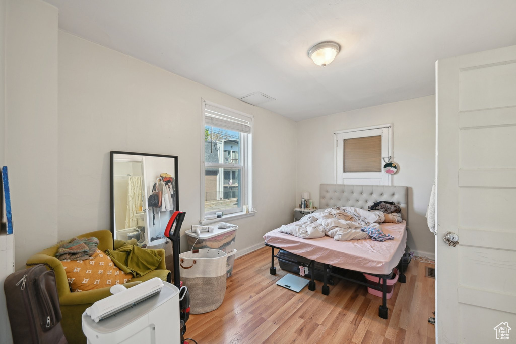 Bedroom featuring wood finished floors and baseboards