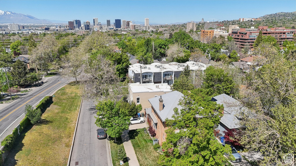 Aerial overview of property's location with nearby urban area and mountains