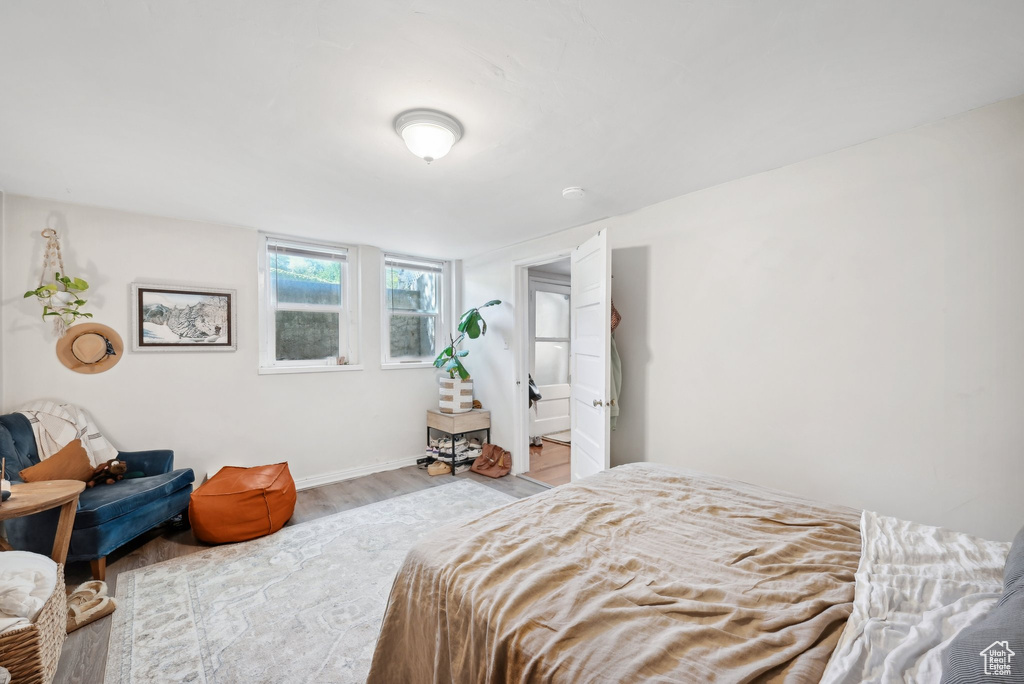 Bedroom with wood finished floors and baseboards