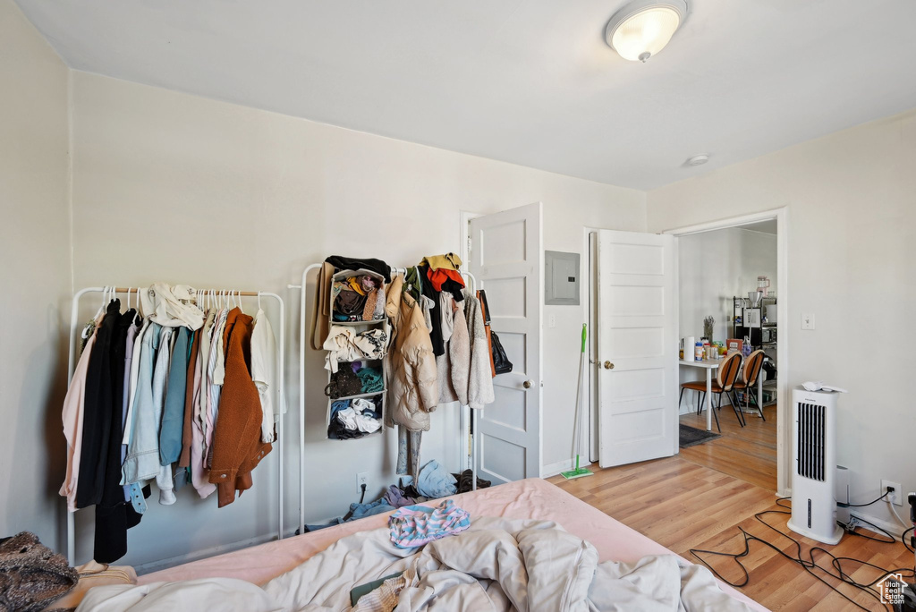 Bedroom featuring wood finished floors and electric panel