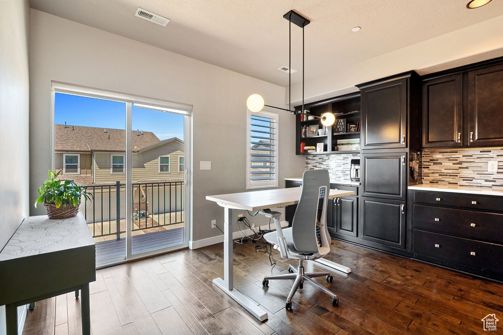 Office featuring dark wood-style floors and baseboards