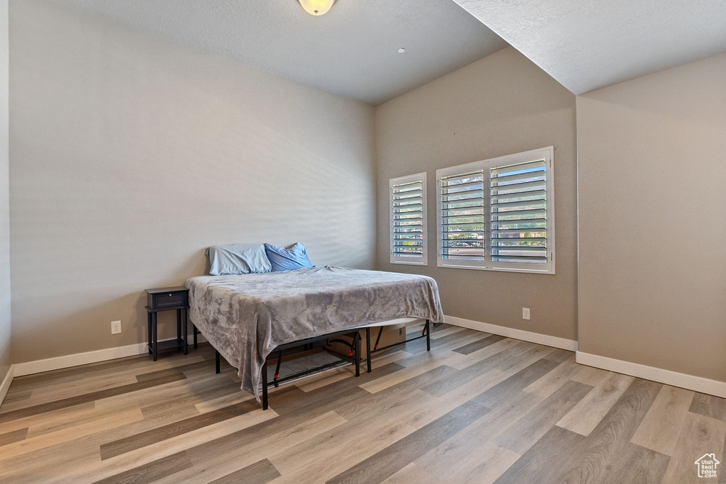 Bedroom featuring wood finished floors and baseboards