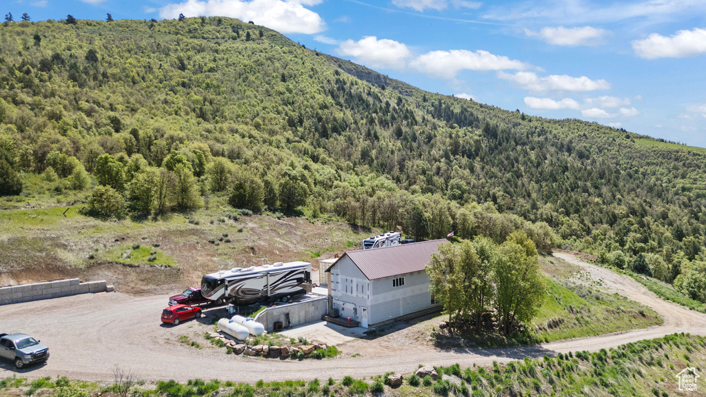 View from above of property with a forest and a mountain backdrop