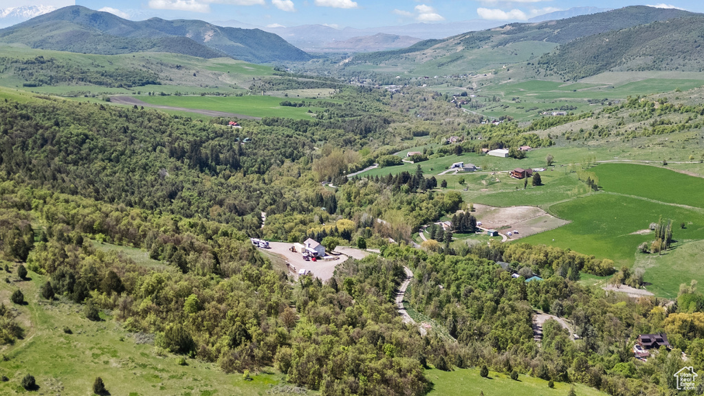 View of property location with mountains and a forest